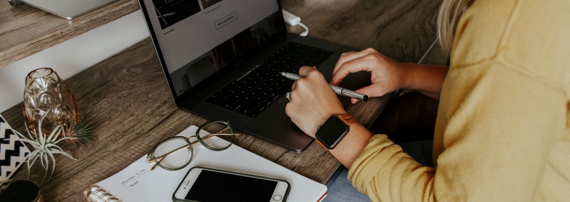 person in blue denim jeans using macbook pro