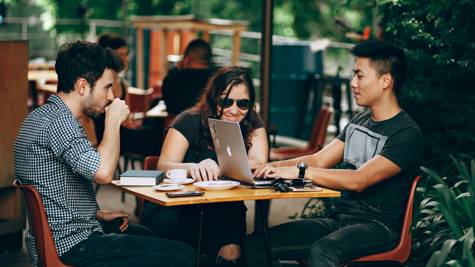 photo of three person sitting and talking